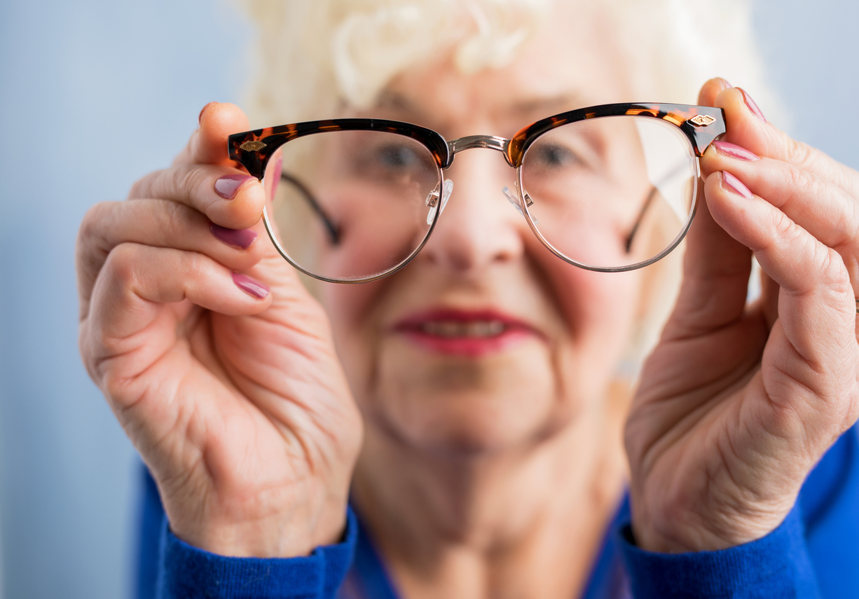 Elderly woman looking through glasses - Rehab First